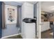 Compact laundry area featuring a stacked washer and dryer adjacent to a modern kitchen at 1310 N Corona St # A, Denver, CO 80218