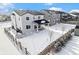 Two-story home with fenced backyard, covered patio, and snow-covered landscaping at 24281 E 40Th Ave, Aurora, CO 80019