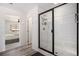 Modern bathroom with a glass shower door and white tile at 24281 E 40Th Ave, Aurora, CO 80019