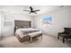 Main bedroom with king bed, ceiling fan, and sitting chair at 24281 E 40Th Ave, Aurora, CO 80019