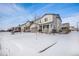 Two-story house with gray siding, double garage, and front yard covered in snow at 24281 E 40Th Ave, Aurora, CO 80019