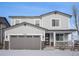 Two-story house with gray siding, a two-car garage, and a front porch at 24281 E 40Th Ave, Aurora, CO 80019