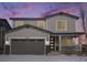 Two-story house with gray siding, a two-car garage, and a front porch at 24281 E 40Th Ave, Aurora, CO 80019