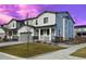 Two-story house with gray siding, stone accents, and a front porch at 24281 E 40Th Ave, Aurora, CO 80019