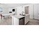 Modern kitchen with white cabinets, stainless steel appliances, and an island at 24281 E 40Th Ave, Aurora, CO 80019