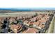 Stunning aerial view of a community with tiled-roof homes, mature trees, and a refreshing community pool at 4648 S Abilene Cir, Aurora, CO 80015