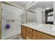 Bathroom features a dual sink vanity with an enclosed, frosted glass shower at 4648 S Abilene Cir, Aurora, CO 80015