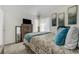 Well-lit bedroom features comfortable bedding, artwork and storage space at 4648 S Abilene Cir, Aurora, CO 80015