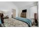 Bright bedroom featuring a large window, patterned bedding, and an adjacent doorway at 4648 S Abilene Cir, Aurora, CO 80015