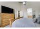 Comfortable bedroom features a wooden dresser and bedframe, as well as entrances to the bathroom and kitchen at 4648 S Abilene Cir, Aurora, CO 80015