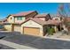 Attractive townhome featuring a tiled roof, attached garages, and well-maintained landscaping in a community setting at 4648 S Abilene Cir, Aurora, CO 80015