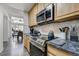 Well-lit kitchen features modern appliances and sleek countertops for the home chef at 4648 S Abilene Cir, Aurora, CO 80015