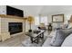 This living room offers a fireplace and natural light, perfect for relaxation at 4648 S Abilene Cir, Aurora, CO 80015