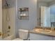 Full bathroom with shower and tub, large mirror, and rack for storage at 12914 Ironstone Way # 201, Parker, CO 80134