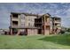Spacious multi-story condo with multiple balconies, brick accents, and well maintained green space at 12914 Ironstone Way # 201, Parker, CO 80134