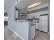 Cozy kitchen featuring white appliances, light blue paint, and a peninsula at 12914 Ironstone Way # 201, Parker, CO 80134