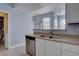 Cozy kitchen with stainless steel dishwasher and double sink with views to the rest of the house at 12914 Ironstone Way # 201, Parker, CO 80134