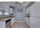 Kitchen area with view into the living room and white appliances at 12914 Ironstone Way # 201, Parker, CO 80134