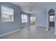 Open living room with light blue walls, white trim and ceiling fan at 12914 Ironstone Way # 201, Parker, CO 80134