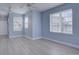Well-lit living area featuring multiple windows, light blue walls and gray wood-look floors at 12914 Ironstone Way # 201, Parker, CO 80134
