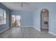Cozy living room with light blue walls, sliding glass door, and gray wood-look floors at 12914 Ironstone Way # 201, Parker, CO 80134