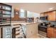 Multi-level kitchen featuring stainless steel appliances, wooden cabinets and exposed brick at 2193 Arapahoe St # 5, Denver, CO 80205