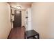 Functional laundry room with a stacked washer and dryer, dark wood-look floors, and a black side table at 2193 Arapahoe St # 5, Denver, CO 80205