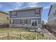 Large backyard featuring a patio, lawn area, and views of the surrounding neighborhood at 27425 E Byers Pl, Aurora, CO 80018