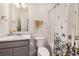 A full bathroom featuring a shower/tub combo with stylish curtain, toilet, and vanity with sink at 27425 E Byers Pl, Aurora, CO 80018