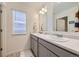 Bathroom featuring double sinks, a well-lit mirror, and clean, modern fixtures at 27425 E Byers Pl, Aurora, CO 80018