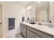 Modern bathroom with dual sinks, large mirrors, updated fixtures, and ample counter space at 27425 E Byers Pl, Aurora, CO 80018