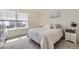 Bright bedroom featuring a cozy bed, neutral tones, and a window view with natural light at 27425 E Byers Pl, Aurora, CO 80018