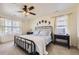 A bright main bedroom with a ceiling fan, neutral tones, and ample natural light from the large windows at 27425 E Byers Pl, Aurora, CO 80018