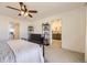 Bedroom with ceiling fan, a comfortable bed, dark dresser, and access to a bright, modern bathroom at 27425 E Byers Pl, Aurora, CO 80018