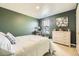 Calm bedroom with an accent wall, neutral-toned furnishings, and natural light at 27425 E Byers Pl, Aurora, CO 80018
