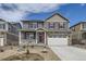 Charming two-story home with stone accents, red shutters, landscaped yard, and a welcoming front porch at 27425 E Byers Pl, Aurora, CO 80018