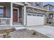 Close-up of a home's exterior showcasing stone accents, a red front door, and a well-maintained front yard at 27425 E Byers Pl, Aurora, CO 80018