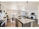 A modern, open kitchen with a large island, stainless steel appliances, and plenty of counter space at 27425 E Byers Pl, Aurora, CO 80018