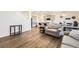 Spacious open-concept space with modern finishes and a view to the kitchen and dining areas at 27425 E Byers Pl, Aurora, CO 80018