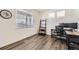 Bright office with large window, sleek desk setup, and modern ladder shelf; a perfect workspace at 27425 E Byers Pl, Aurora, CO 80018