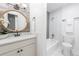 Updated bathroom with a vanity, bathtub, toilet, and marble-style tile at 14396 E Florida Ave # B, Aurora, CO 80012