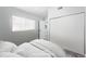 Virtually staged bedroom with a striped comforter and built-in closet at 14396 E Florida Ave # B, Aurora, CO 80012