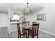 Charming dining area with glass-top table and four chairs, situated near the kitchen at 14396 E Florida Ave # B, Aurora, CO 80012