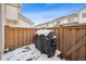 Small back patio with grill and snow on the ground at 2054 S Xenia Way # 59, Denver, CO 80231