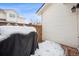 Small backyard with grill and snow on the ground at 2054 S Xenia Way # 59, Denver, CO 80231