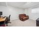 Finished basement with a leather couch and home office setup at 2054 S Xenia Way # 59, Denver, CO 80231