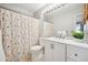 Clean bathroom with a floral shower curtain and white vanity at 2054 S Xenia Way # 59, Denver, CO 80231