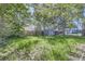 Spacious backyard featuring green grass, mature trees, privacy fencing, and an enclosed outdoor space at 1388 Kenton, Aurora, CO 80010