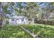 Lush backyard featuring green grass, pathway, mature trees, and a tranquil outdoor space at 1388 Kenton, Aurora, CO 80010