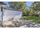 Private backyard featuring a detached garage, grassy area, mature trees, and plenty of space at 1388 Kenton, Aurora, CO 80010